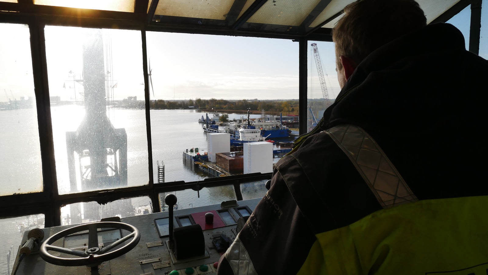 Ein Mann schaut von einem Kran über die Weser