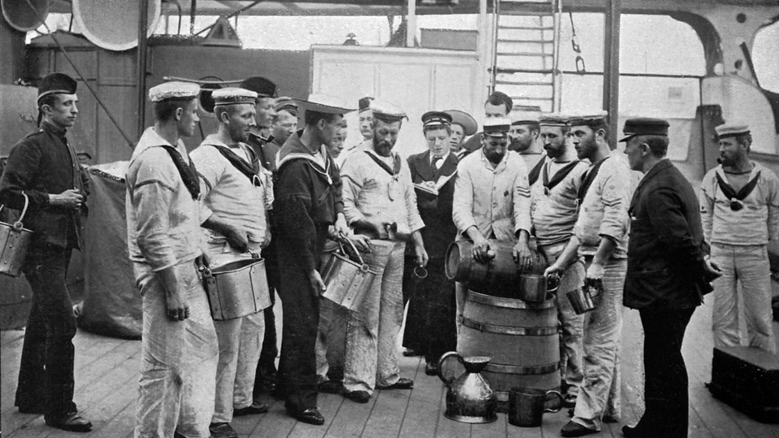 Issuing rum on board HMS 'Royal Sovereign', 1896. Half a gill of rum is allowed to each man. A print from The Navy and Army Illustrated, 3rd January 1896. 