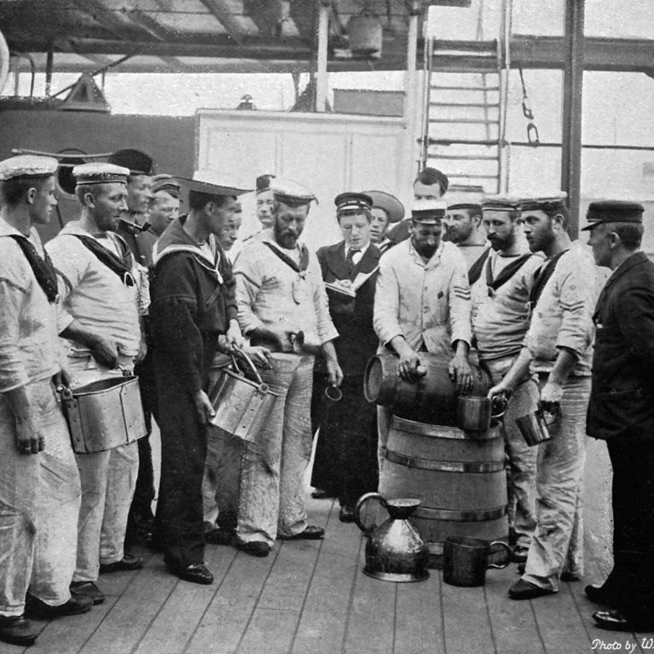 Issuing rum on board HMS 'Royal Sovereign', 1896. Half a gill of rum is allowed to each man. A print from The Navy and Army Illustrated, 3rd January 1896. 