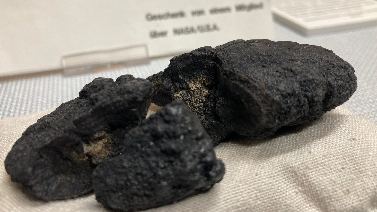 ein schwarzer zerbrochener Stein auf einem Tisch