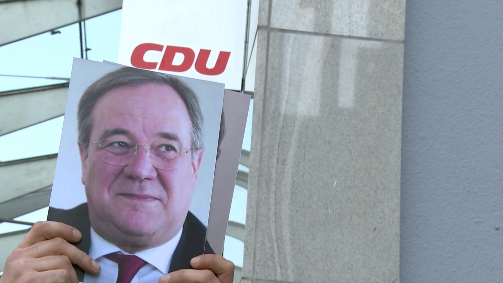 Ein Bild vom neuen Kanzlerkandidat Armin Laschet hinter einem CDU Logo. 