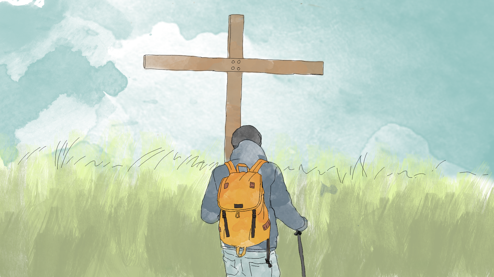 Ein Mann steht vor einem großen Holzkreuz